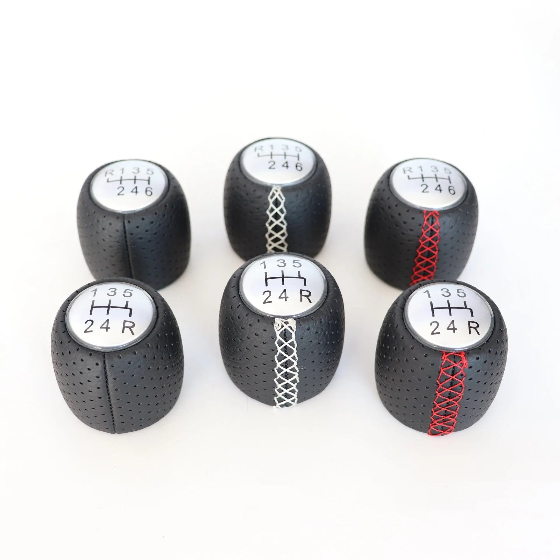 Sewn wrapped leather perforated style handball gear knob for Alpha vehicles in black, red, and white colour options.