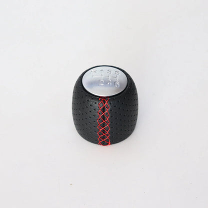 Sewn wrapped leather perforated style handball gear knob for Alpha vehicles in black, red, and white colour options.