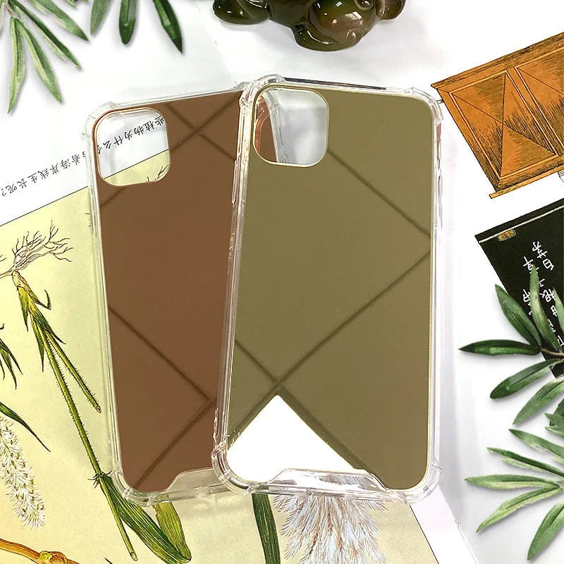 Silver mirrored phone case for Apple iPhone on a table, showing reflective back.