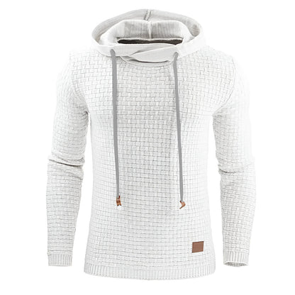 A man wearing a cotton-polyester blend hoodie available in nine colours including black, navy, and red.
