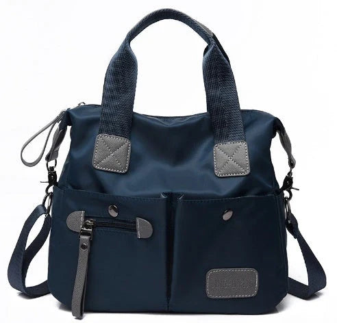 A fashionable and versatile ladies tote bag with multiple compartments and carrying options for the modern woman on the move.