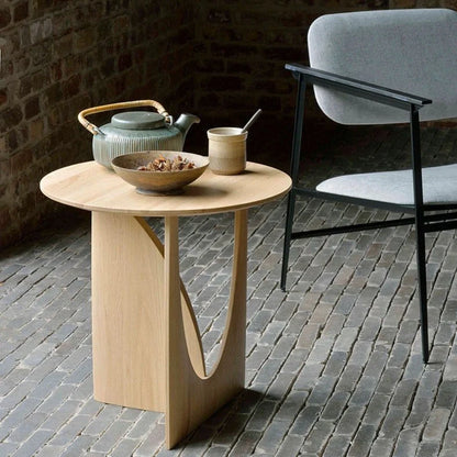 Round solid wood bedside table with geometric legs in walnut finish measuring 50cm diameter