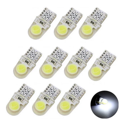 Pack of ten T10 wedge base LED car bulbs with COB chips in various colours on a white background