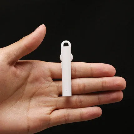 Black wireless Bluetooth headset showing compact 5.6cm design with charging cable