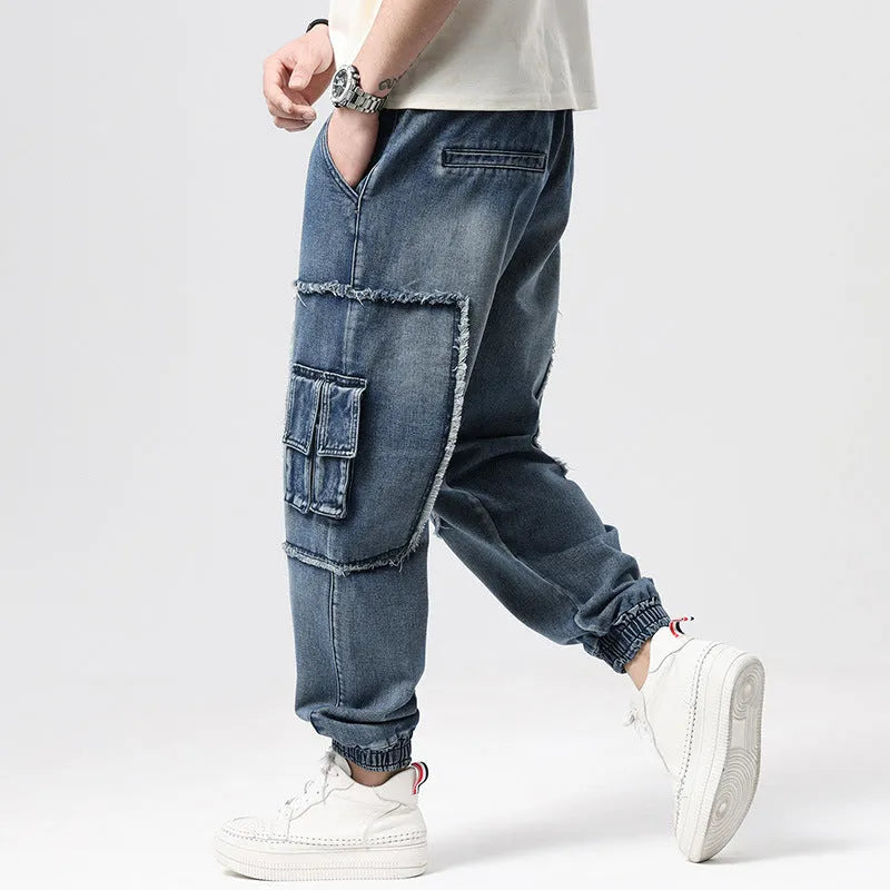Men's high-waisted loose denim trousers with multiple pockets showing straight leg opening