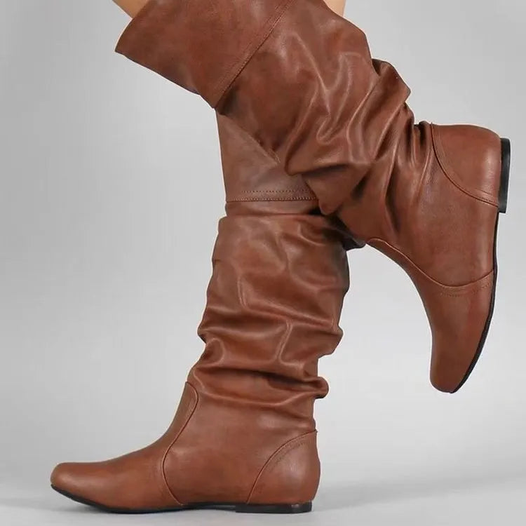 Women's flat heel long boots in black, slip-on style with a high cylinder shaft and rubber sole.