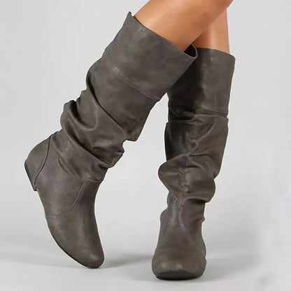Women's flat heel long boots in black, slip-on style with a high cylinder shaft and rubber sole.