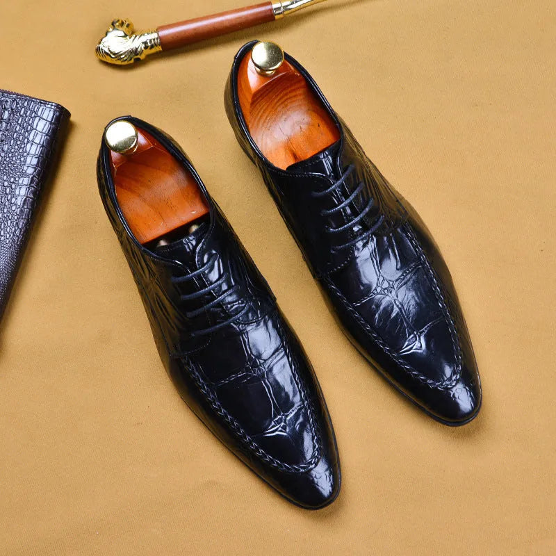 Black men's leather casual shoes with alligator pattern and metal horse bit buckle on a rubber sole.