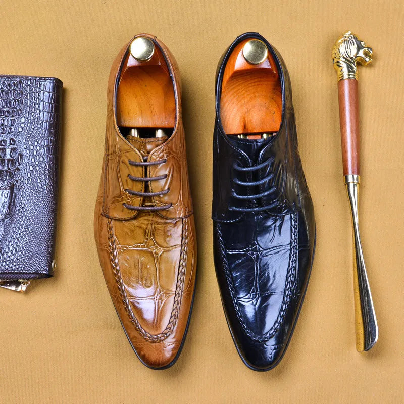 Black men's leather casual shoes with alligator pattern and metal horse bit buckle on a rubber sole.