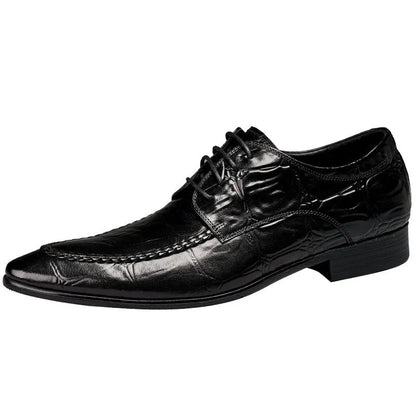 Black men's leather casual shoes with alligator pattern and metal horse bit buckle on a rubber sole.