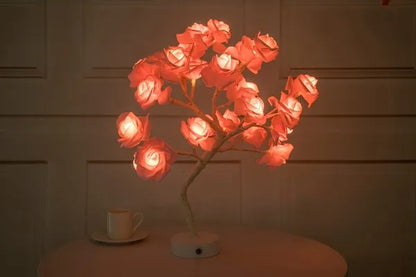 White and red rose flower LED lamp on a table with bonsai tree shape and warm white glow.