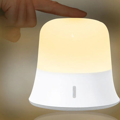 White rechargeable bedside night light with touch controls showing dimming and colour options