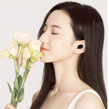 Black and white M1 wireless Bluetooth earbuds with a charging case on a neutral background.
