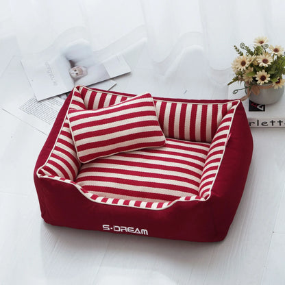 Removable washable dog kennel mat with fabric pillow in navy stripes and blue or red colour options.