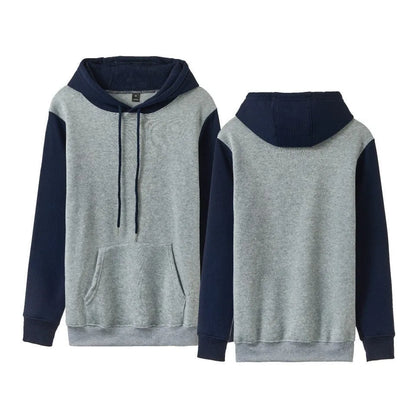 Man wearing a white loose fleece-lined hoodie with contrast stitching, showing the pullover style and hood.