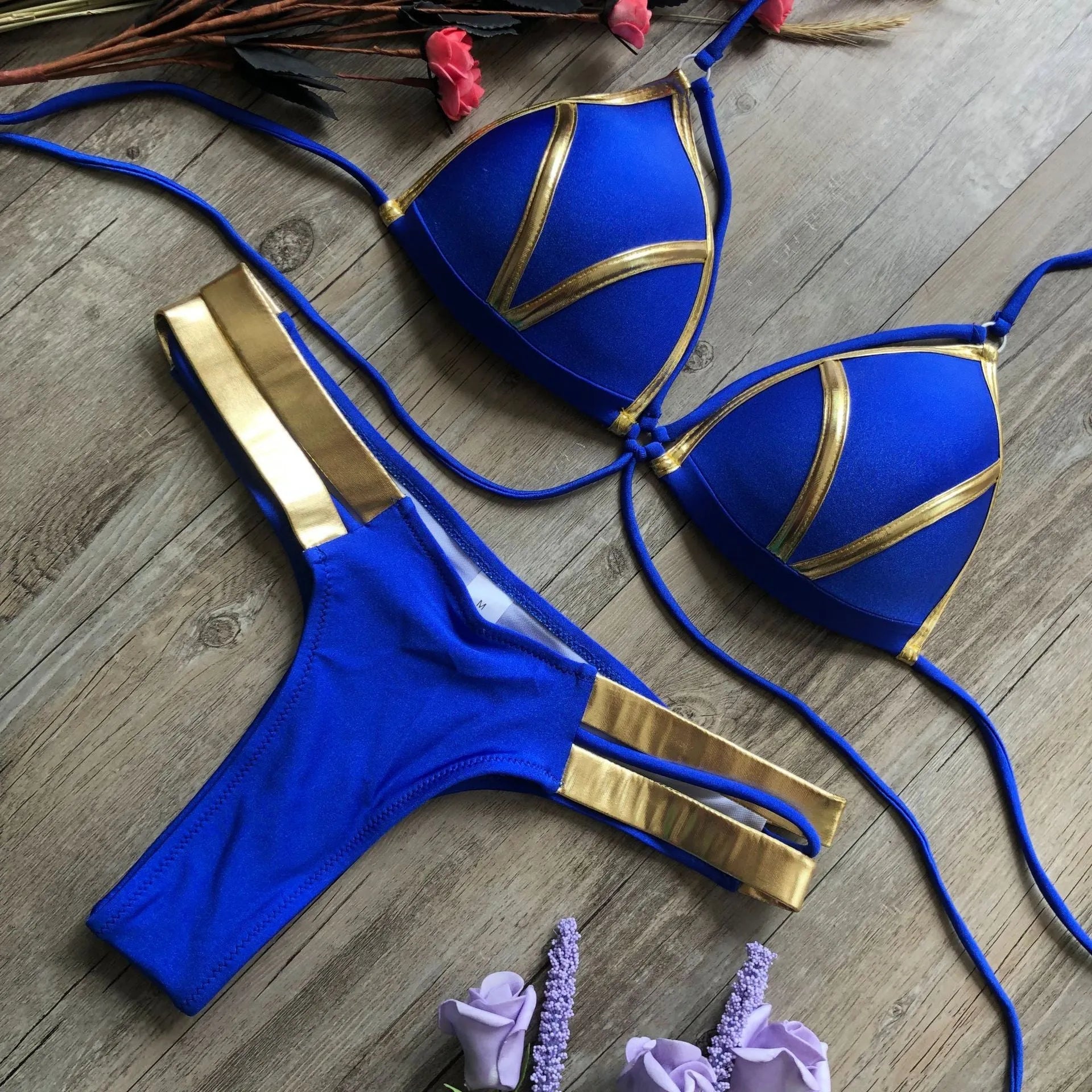 Women's bronzing bikini with padded cups in a selection of colours including black, blue, leopard print, and snakeskin print.
