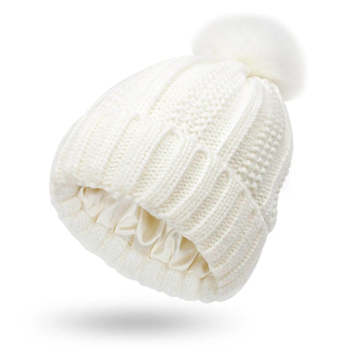 Woman wearing a wine red wool beanie hat with a faux fur pom pom and satin lining.