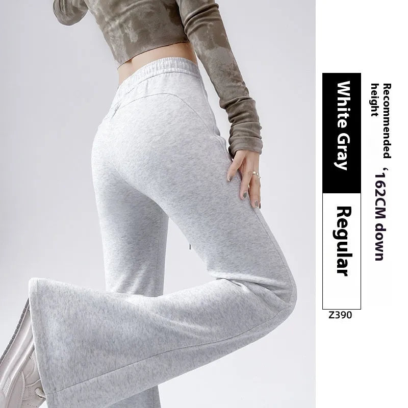 Women's high waist bootcut sports pants in black cotton with fleece lining and micro elasticity, slightly flared leg.