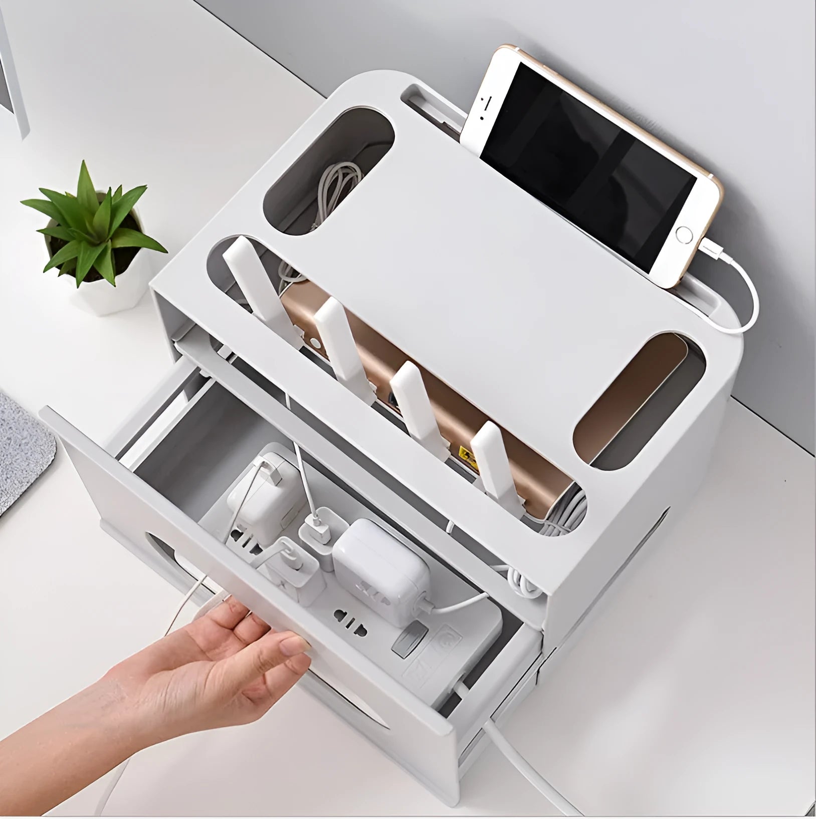 A grey and a white plastic storage box for organising a wireless router and its cables.