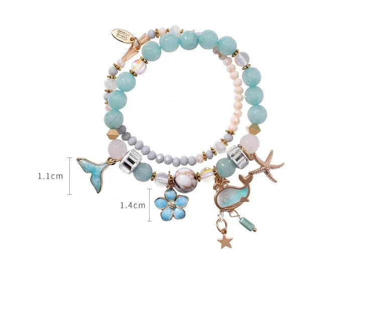 Whale tail bracelet with retro flower and starfish accents, a charming nautical accessory for UK fashionistas