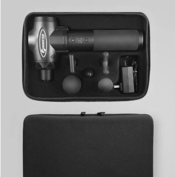 Black and white handheld percussion muscle massage gun with four interchangeable foam heads on a grey background.