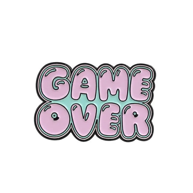 Stereo game console badge made of alloy metal for bag or jacket attachment.