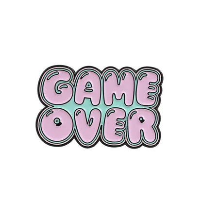 Stereo game console badge made of alloy metal for bag or jacket attachment.