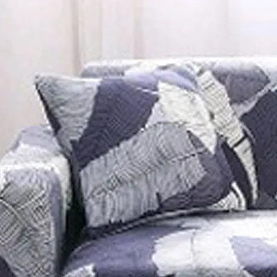 Printed stretchable sofa slipcover with geometric abstraction pattern on a three-seater sofa, showing tight fit and modern design.