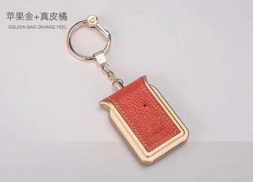 Black leather Bluetooth Dual SIM Adapter keychain with Nano SIM slot and Micro USB port.