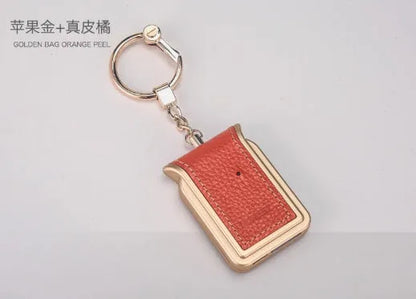Black leather Bluetooth Dual SIM Adapter keychain with Nano SIM slot and Micro USB port.