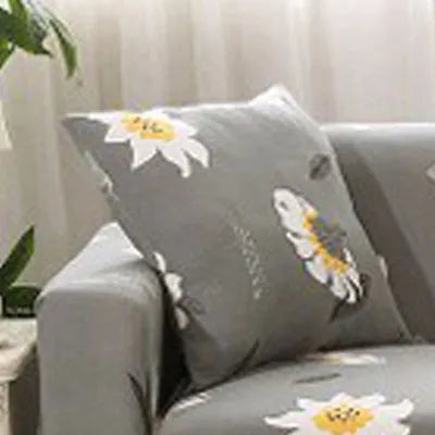 Printed stretchable sofa slipcover with geometric abstraction pattern on a three-seater sofa, showing tight fit and modern design.