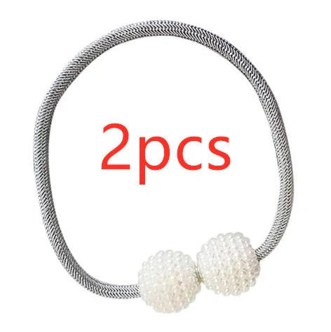 Magnetic curtain tiebacks with white pearl beads and fabric loops holding gathered curtain