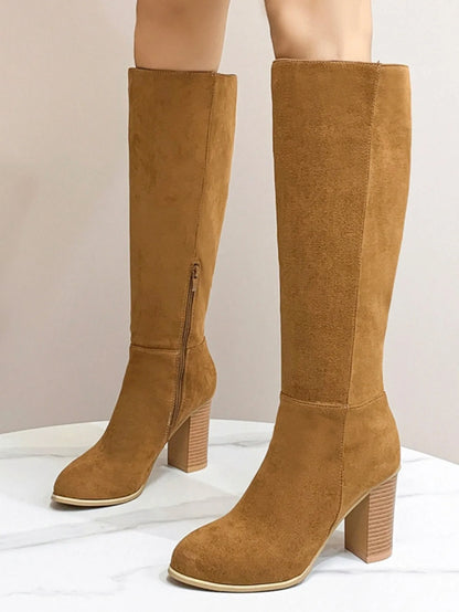 Black square toe high heel fashion boots for women on a neutral background