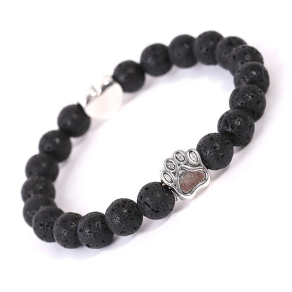 Tiger's eye stone bracelet with dog paw and Indian agate beaded designs on a wrist.