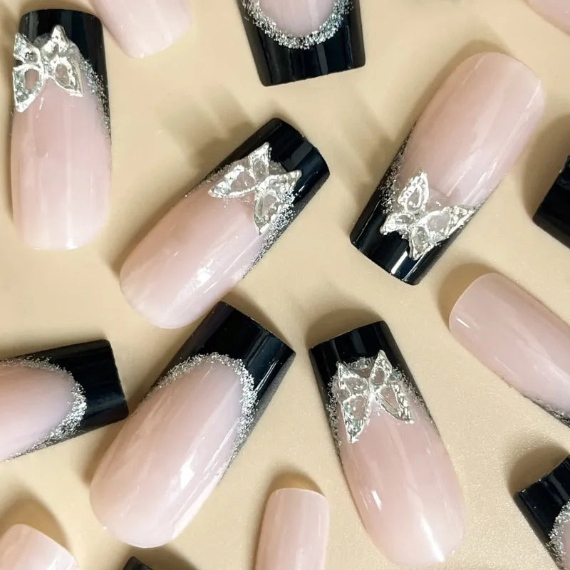 Black French style butterfly nail armour set with glitter decoration on medium-length nails