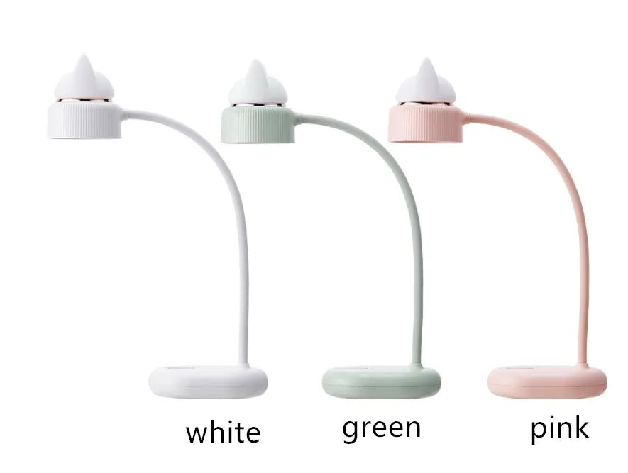 White clip-on LED desk lamp with built-in battery attached to a desk edge.