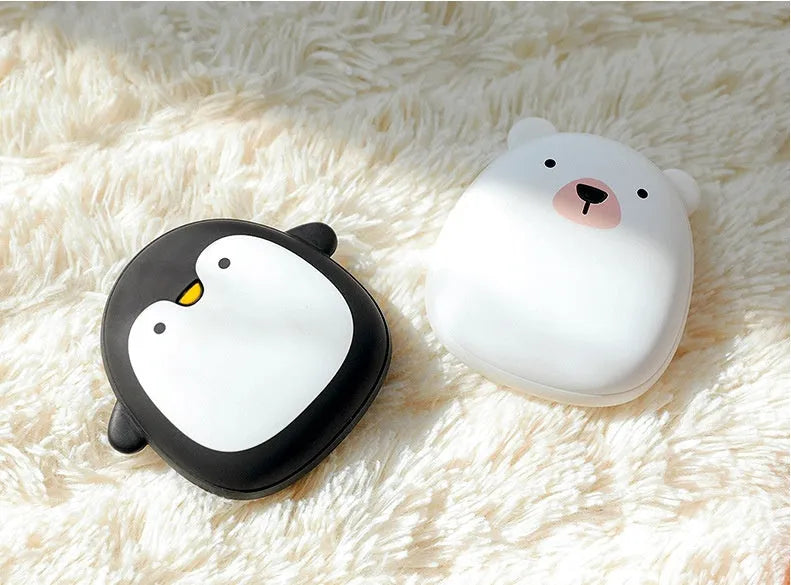 USB rechargeable hand warmers and portable power bank with double-side heating in cute cartoon penguin and polar bear designs, featuring an ABS plastic shell measuring 83 mm by 78 mm by 35 mm and a soft-touch finish.