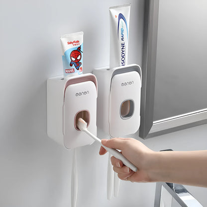 Automatic wall-mounted toothpaste dispenser in blue, grey, and pink colours with LED touch sensor.