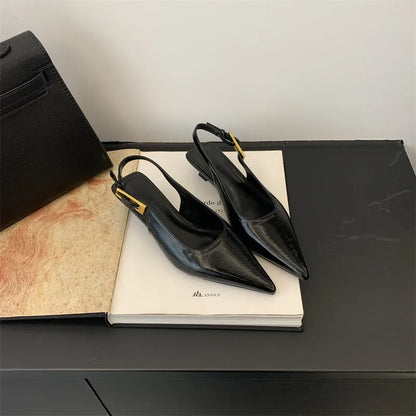 Women's black leather pointed toe shoes with low heel and thin strap.