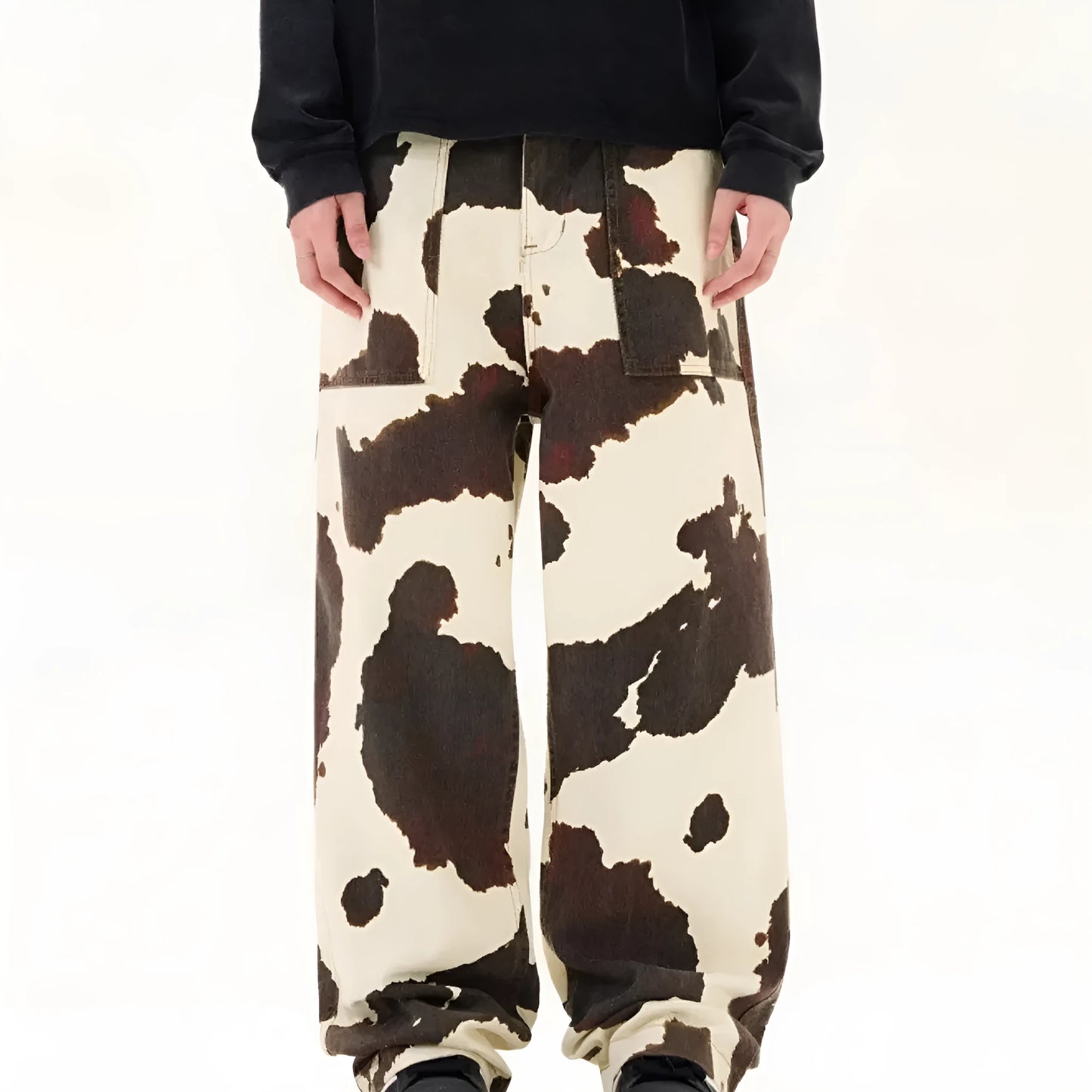 Men's straight-leg casual trousers with a retro-style cows pattern print in a brown colour.