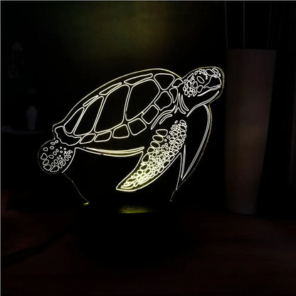3D acrylic turtle-shaped LED night light showing one of its 16 colour options on a bedroom shelf.