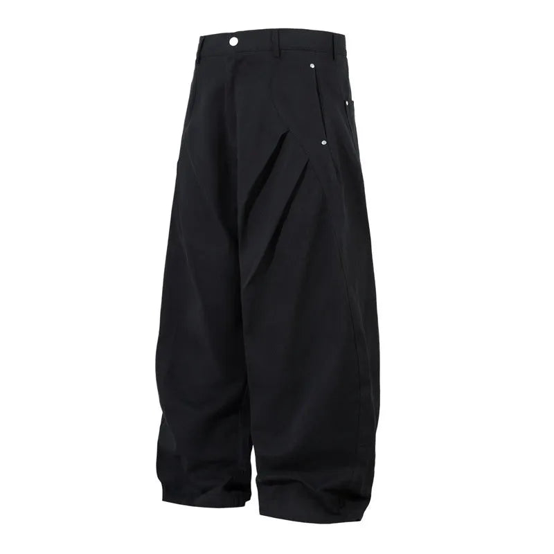 Men's black cotton pleated casual trousers with a loose-fitting wide-leg silhouette.