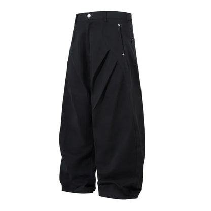 Men's black cotton pleated casual trousers with a loose-fitting wide-leg silhouette.