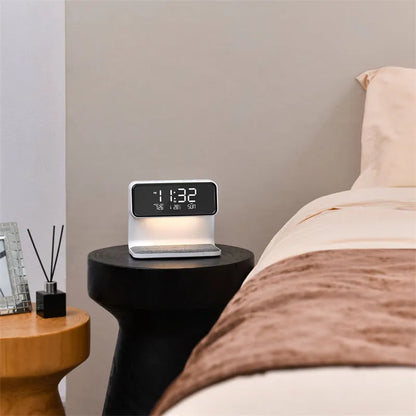 White 3-in-1 bedside lamp with wireless charging pad, LCD alarm clock screen, and touch controls.
