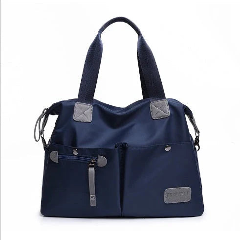 A fashionable and versatile ladies tote bag with multiple compartments and carrying options for the modern woman on the move.