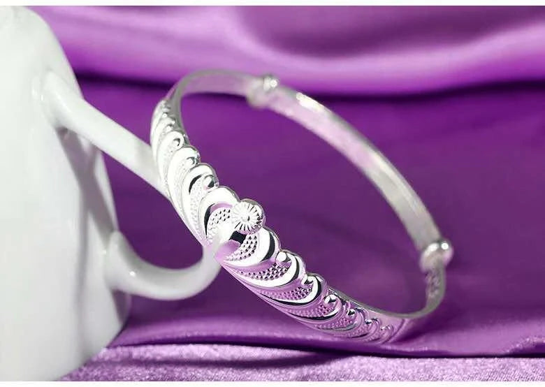 A close-up view of the elegant Crown Bracelet, showcasing its intricate crown-shaped design and shiny, rhodium-plated finish.