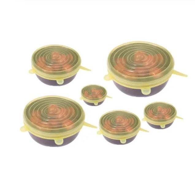 Set of six flexible silicone pot lids in assorted sizes on a kitchen counter.