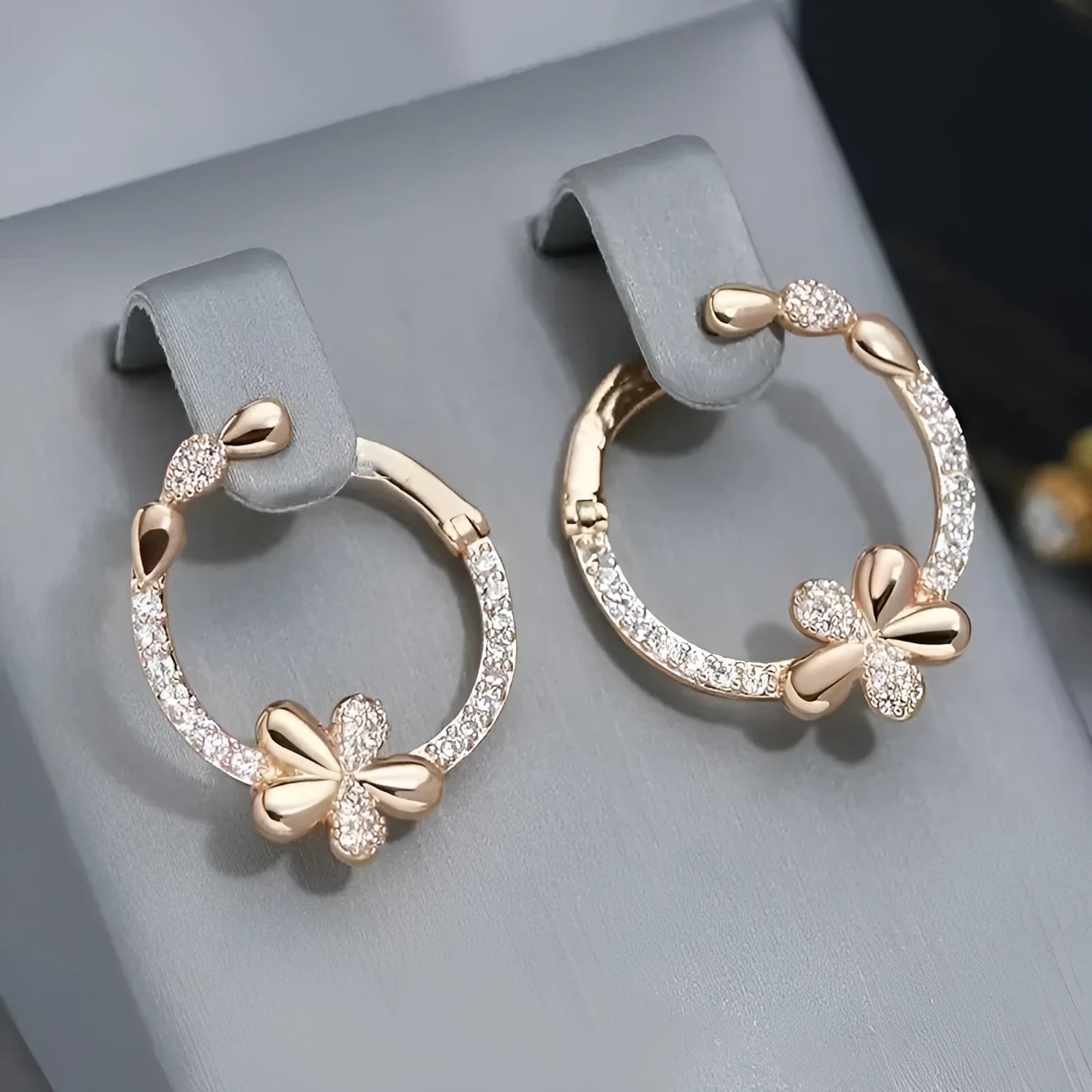 A pair of round ring earrings for women made from electroplated copper with a geometric design.