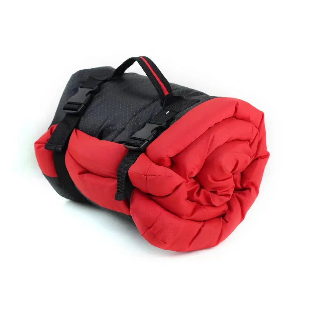 Blue foldable outdoor dog bed shown both fully unfolded and folded with buckles, on grass.