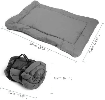 Blue foldable outdoor dog bed shown both fully unfolded and folded with buckles, on grass.